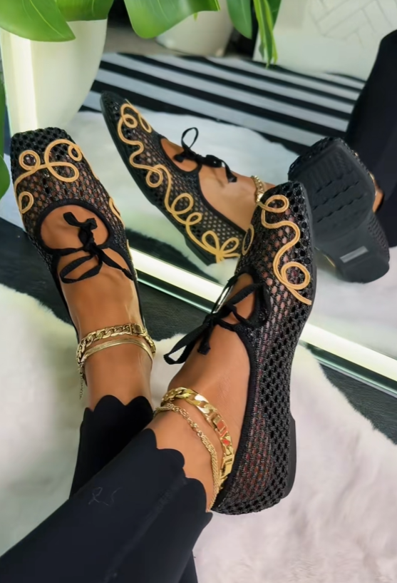 Close-up of shoes on feet — gold anklet adds luxury feel
